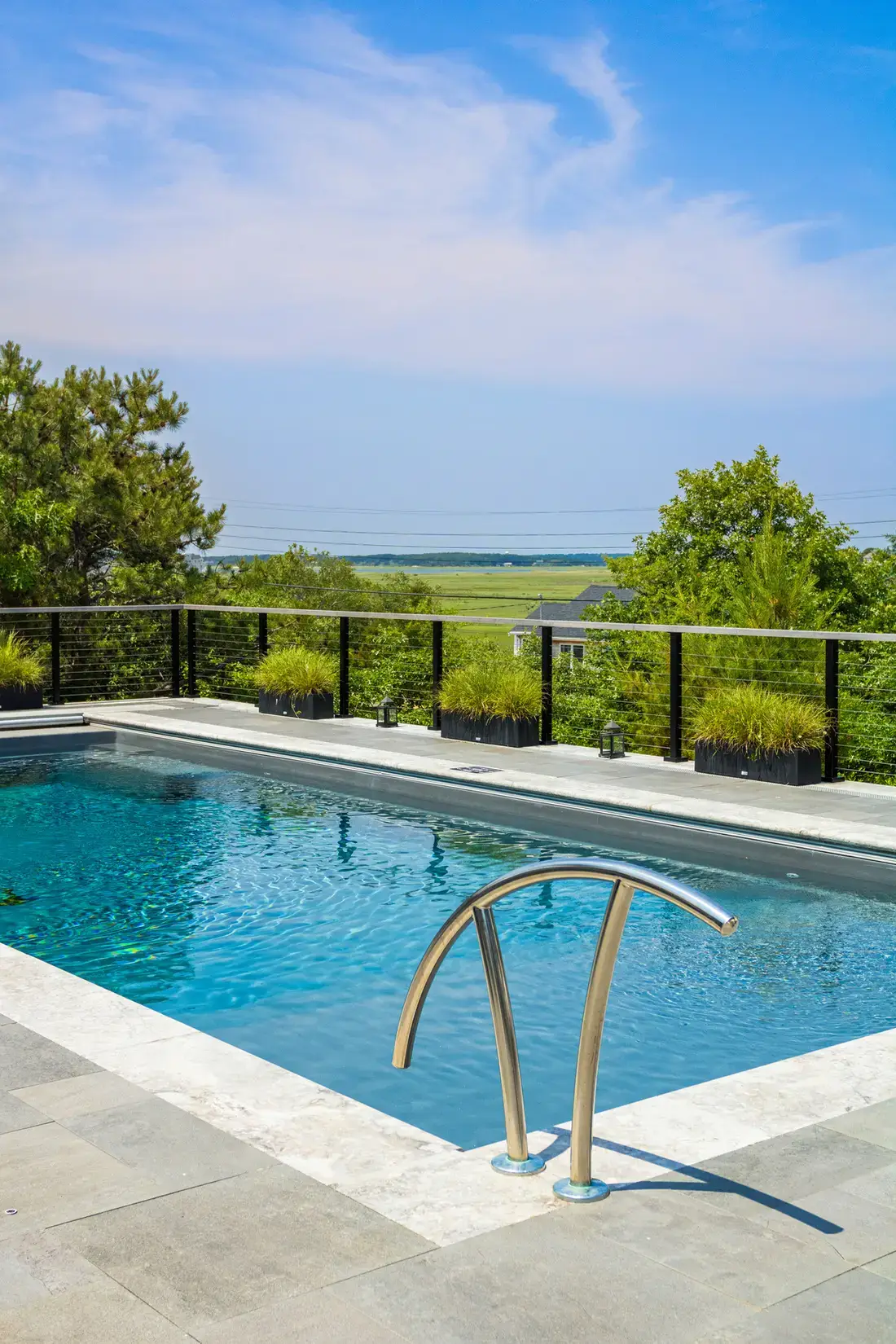 Everblue porcelain pavers on a pool deck overlooking a coastal marsh