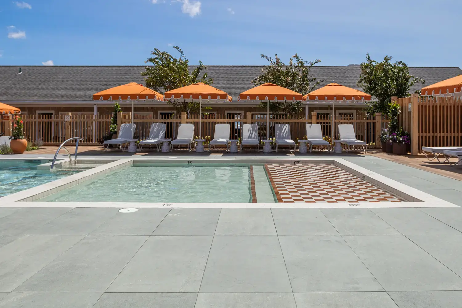 Everblue porcelain pavers around a pool with cabanas and loungers
