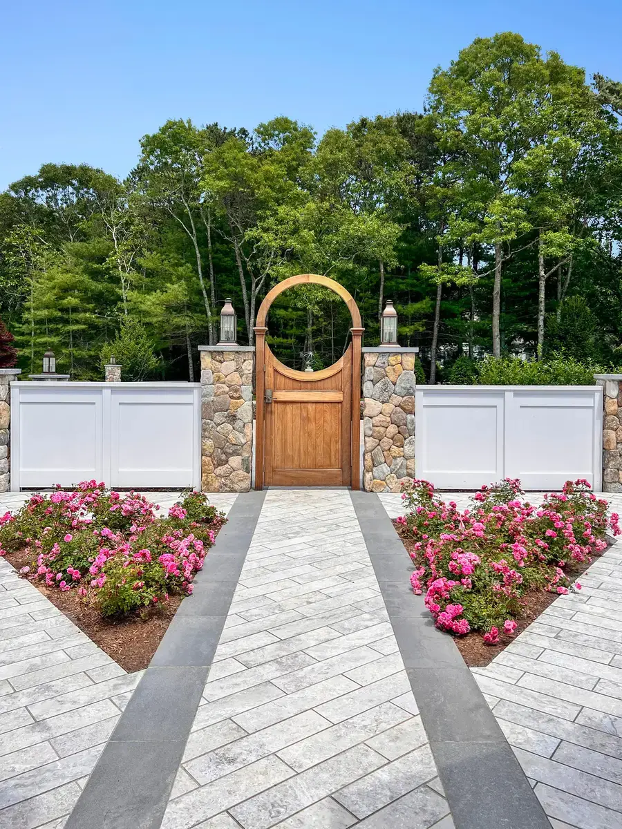 Everblue porcelain paver walkway in herringbone leading to a garden gate